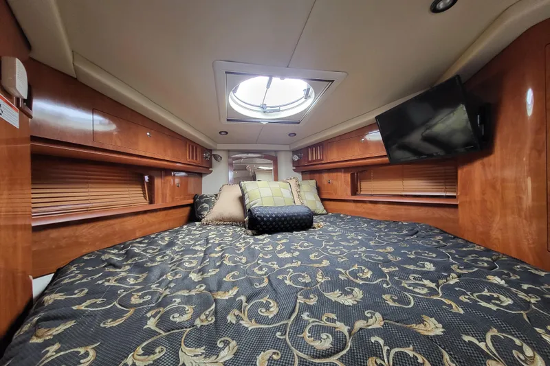 Slide: The Image of Luxurious cabin interior of 2006 Four Winns 348 Vista yacht with elegant bedding and wood finish. - 38