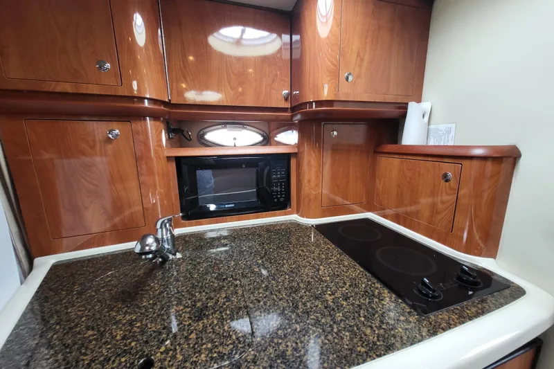 Slide: The Image of Luxurious 2006 Four Winns 348 Vista yacht kitchen with wood cabinets and modern appliances. - 39