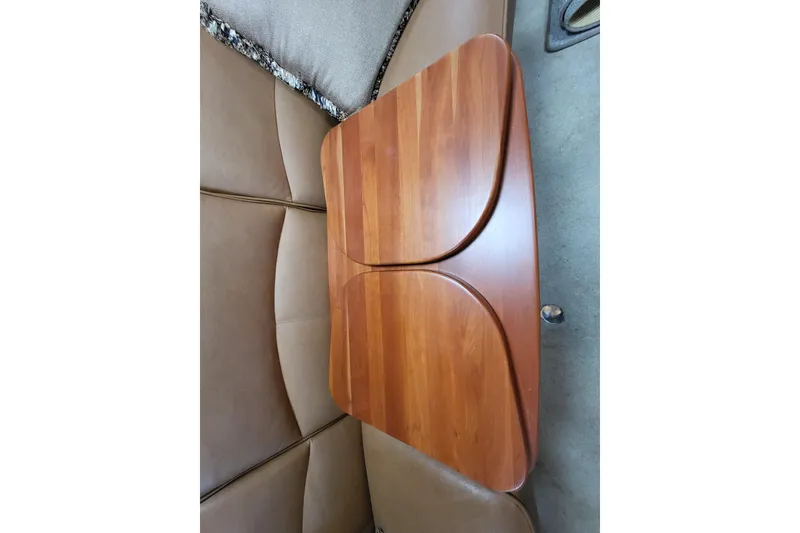 Slide: The Image of Wooden table in 2006 Four Winns 348 Vista boat interior, surrounded by cushioned seating. - 43