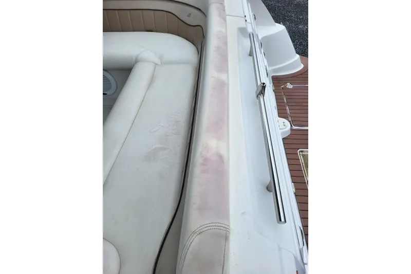 Slide: The Image of 2006 Four Winns 348 Vista boat interior with white seating and wood deck. - 45