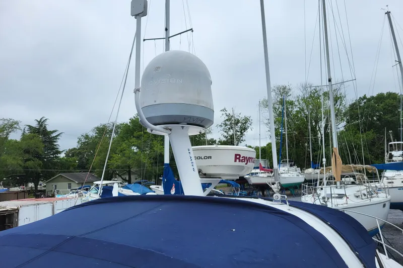 Slide: The Image of 2006 Four Winns 348 Vista boat with radar equipment, docked among other sailboats. - 47