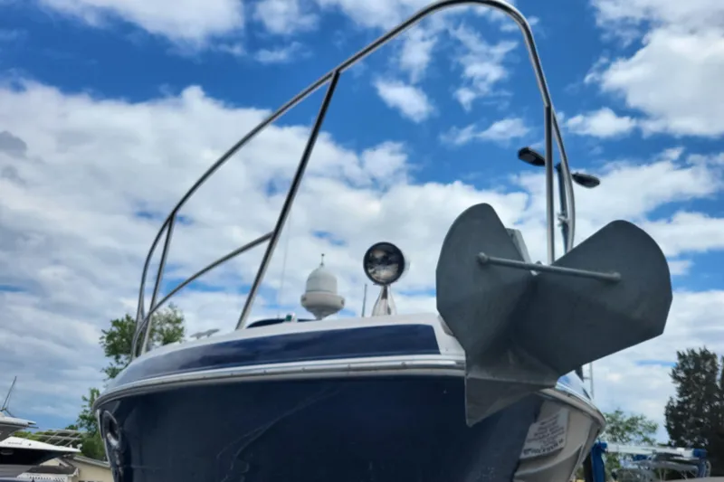 Slide: The Image of 2006 Four Winds Vista 348 boat with anchor, under a partly cloudy sky. - 8