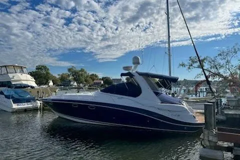 Slide: The Image of 2006 Four Winds Vista 348 boat docked at a marina under a partly cloudy sky. - 9