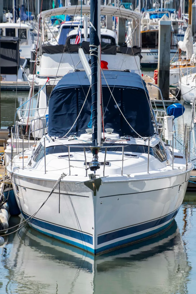 The Image of Hunter 45 CC sailboat from 2005 docked in a marina, surrounded by other boats. - 0