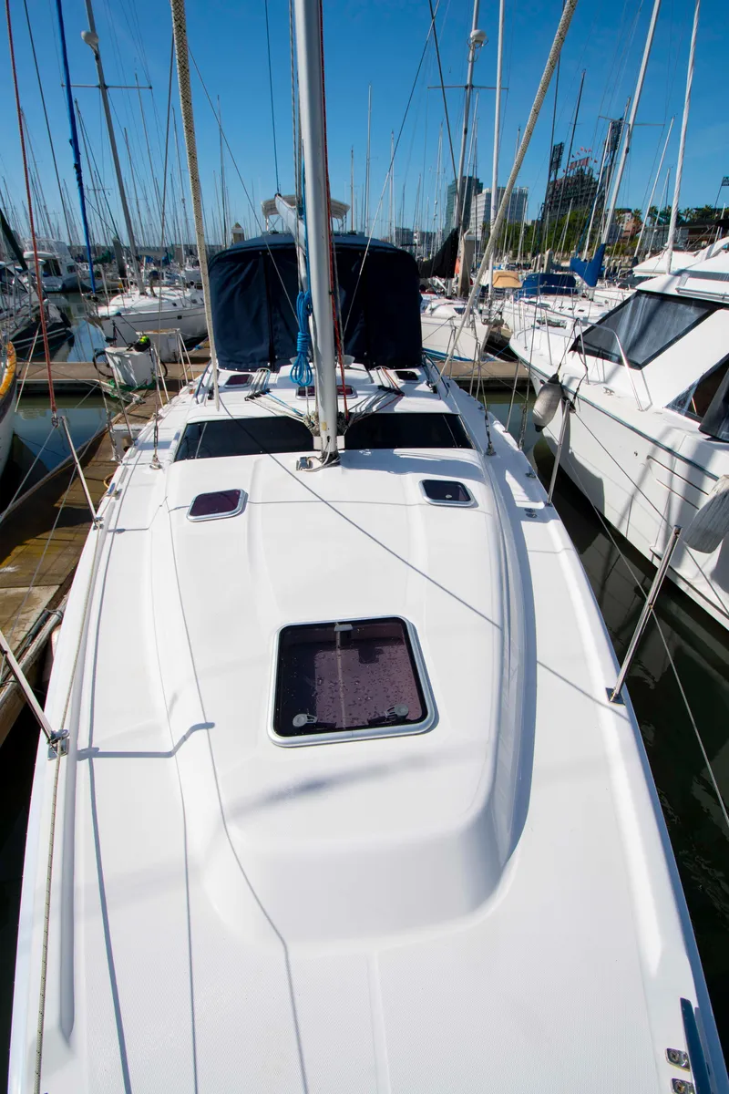 Slide: The Image of Sailboat Hunter 45 CC, 2005 model, docked in a marina with clear blue skies. - 11