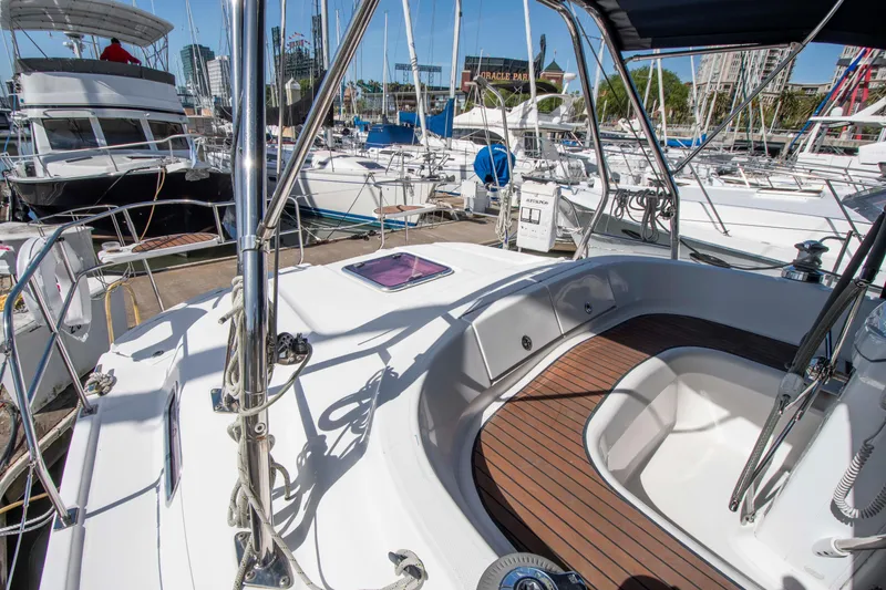 Slide: The Image of 2005 Hunter 45 CC sailboat cockpit with teak flooring, docked at marina. - 12