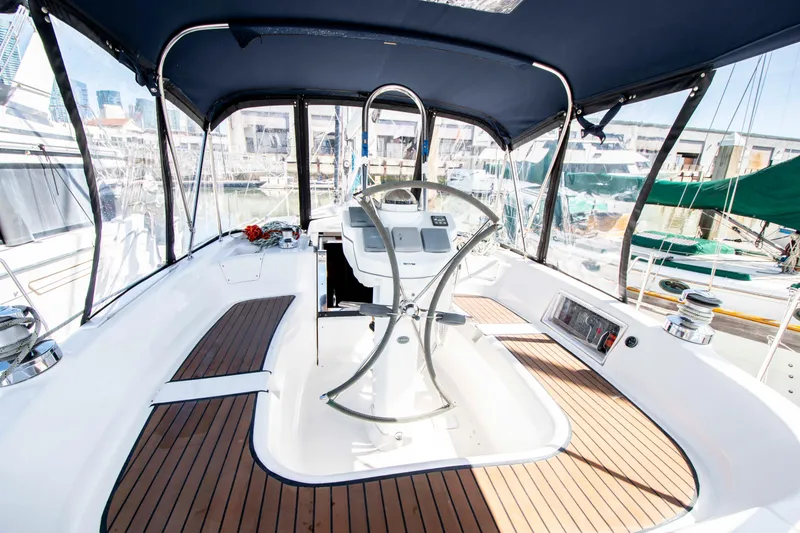 Slide: The Image of Cockpit of 2005 Hunter 45 CC sailboat with wooden flooring and modern steering wheel. - 14