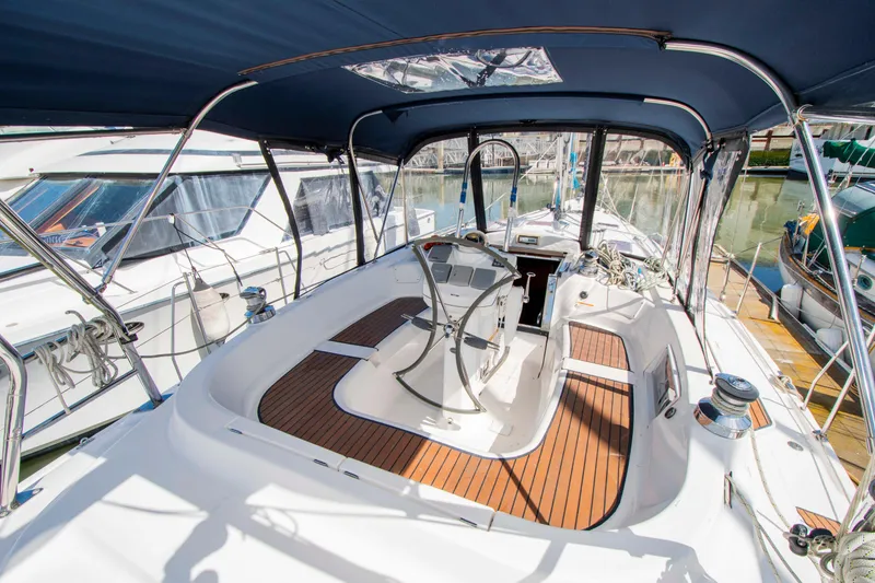 Slide: The Image of 2005 Hunter 45 CC sailboat cockpit with wooden deck and steering wheel. - 15