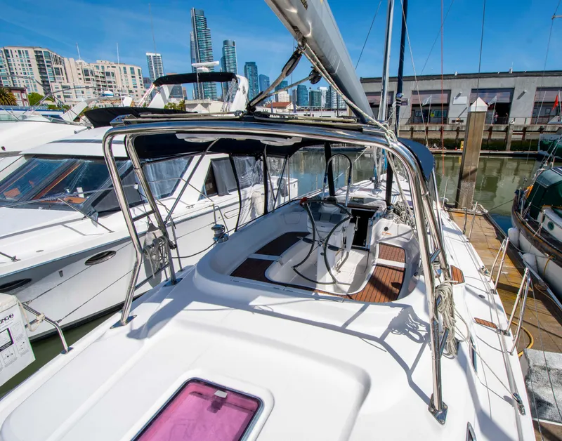 Slide: The Image of Hunter 45 CC sailboat, 2005 model, docked in a marina with city skyline background. - 16