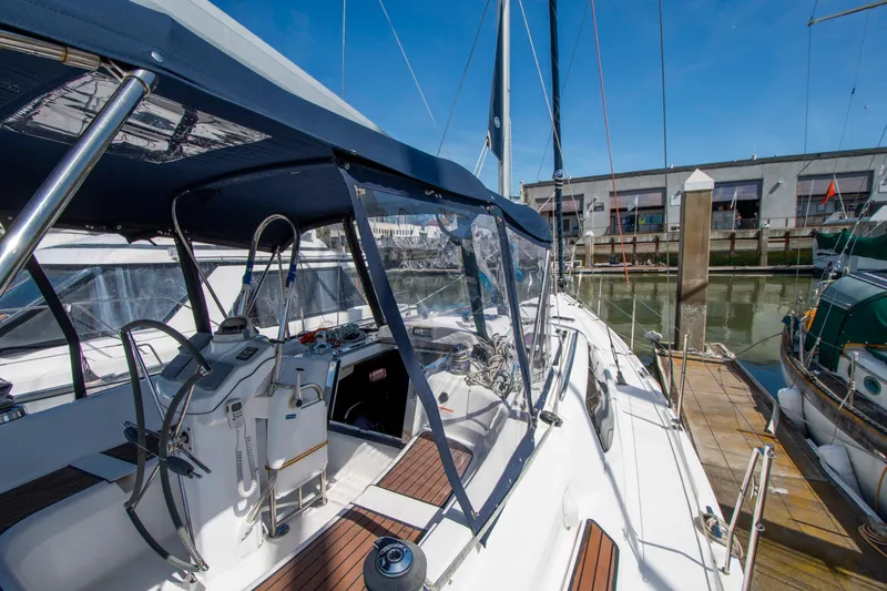 Slide: The Image of 2005 Hunter 45 CC sailboat docked, featuring spacious cockpit and modern design. - 17