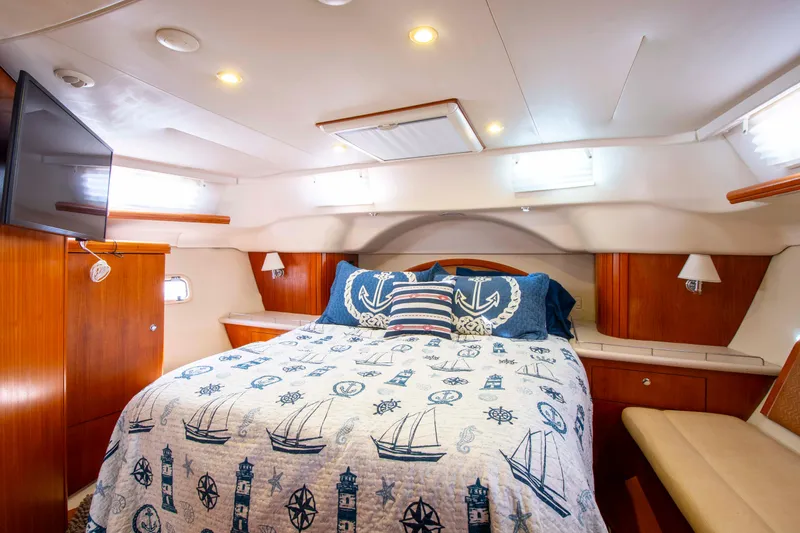 Slide: The Image of Luxurious cabin interior of 2005 Hunter 45 CC yacht with nautical-themed bedding. - 19