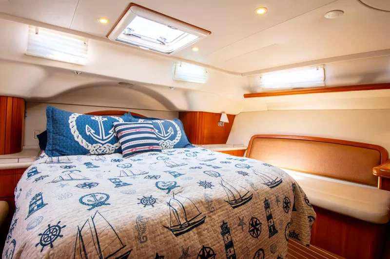Slide: The Image of Cozy cabin interior of 2005 Hunter 45 CC sailboat with nautical-themed bedding. - 20
