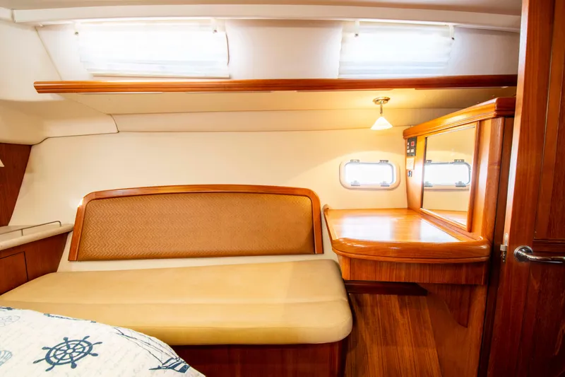 Slide: The Image of Interior of 2005 Hunter 45 CC sailboat with wooden furnishings and cozy seating area. - 21
