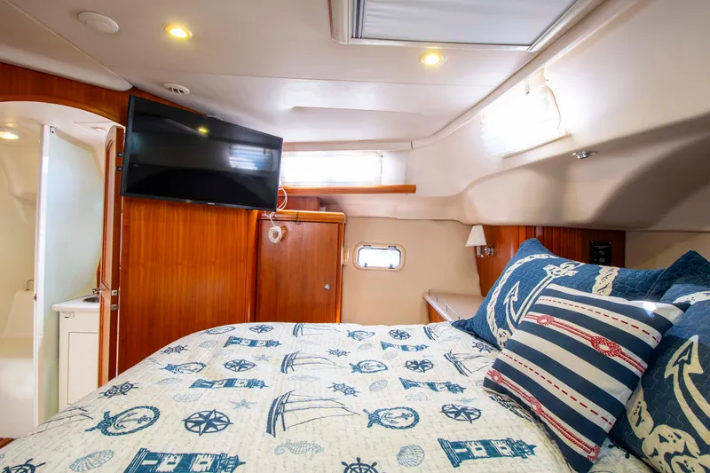 Slide: The Image of Luxurious cabin interior of 2005 Hunter 45 CC yacht with nautical-themed bedding. - 23