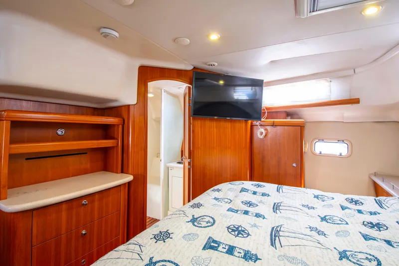 Slide: The Image of Interior of 2005 Hunter 45 CC yacht with cozy cabin and nautical-themed bedding. - 24