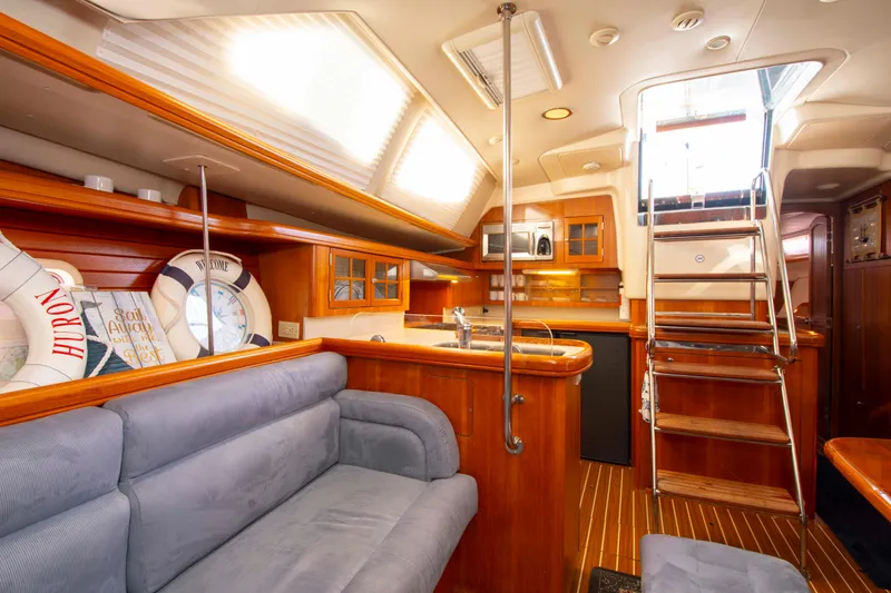 Slide: The Image of Interior of 2005 Hunter 45 CC yacht with cozy seating and wooden finishes. - 34