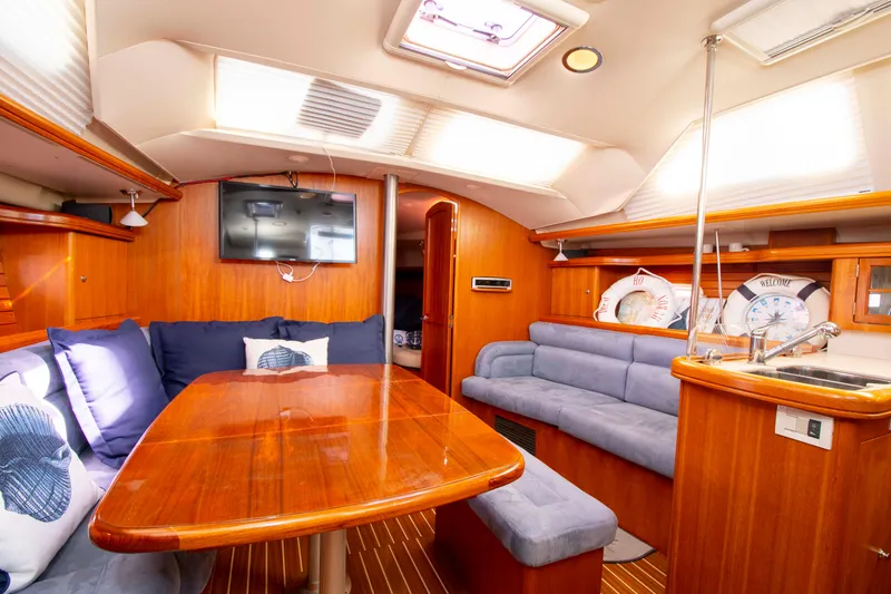 Slide: The Image of Interior of 2005 Hunter 45 CC yacht with wooden furnishings and cozy seating area. - 35