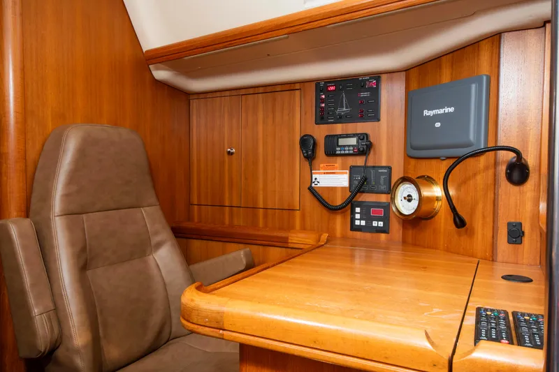 Slide: The Image of Navigation station in 2005 Hunter 45 CC yacht with control panel and seating. - 36