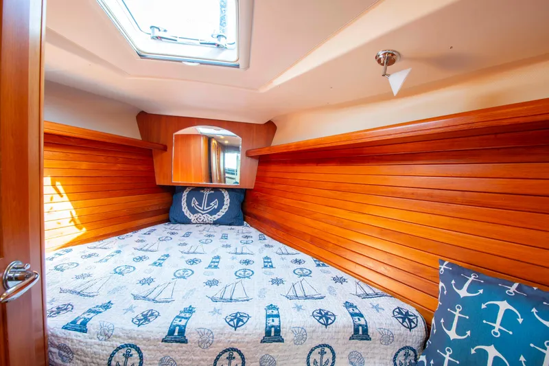 Slide: The Image of Cozy cabin interior of 2005 Hunter 45 CC sailboat with nautical-themed bedding. - 38