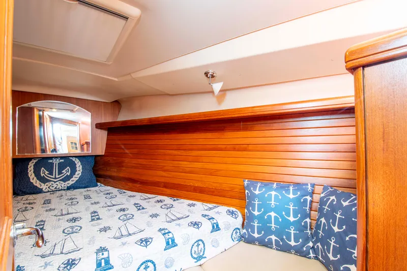 Slide: The Image of Cozy cabin interior of 2005 Hunter 45 CC sailboat with nautical-themed bedding. - 39
