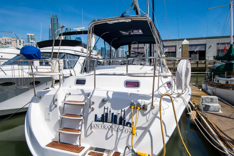 Slide: The Image of 2005 Hunter 45 CC sailboat docked in marina, featuring San Francisco skyline graphic. - 4