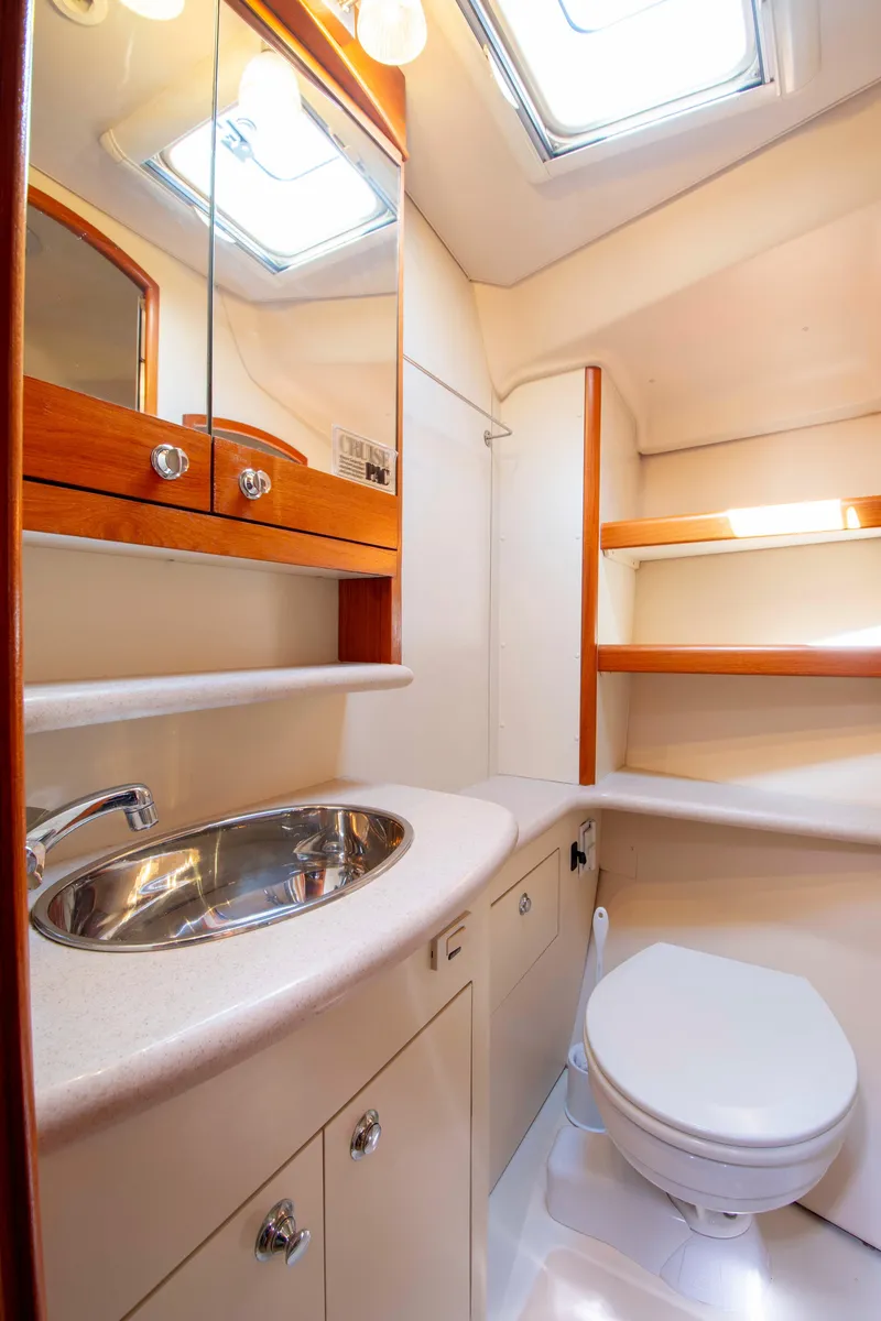 Slide: The Image of Luxurious bathroom in 2005 Hunter 45 CC yacht with sink, toilet, and wooden cabinetry. - 40