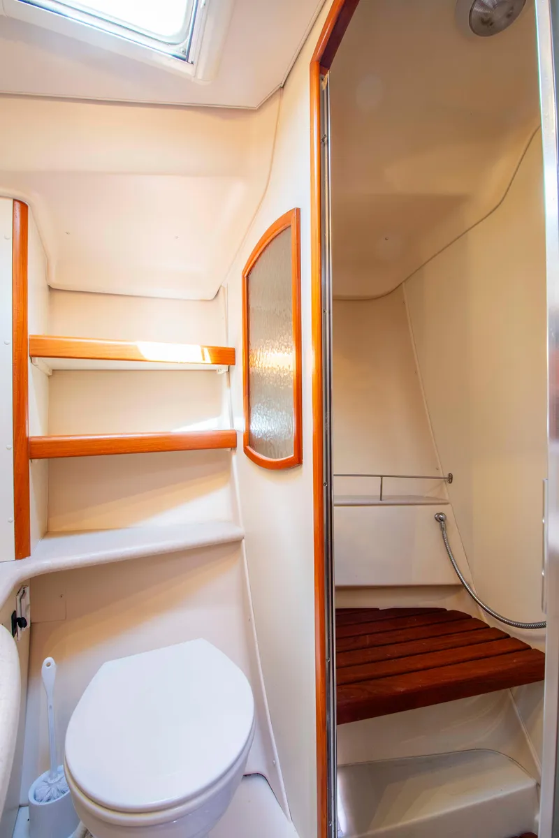 Slide: The Image of 2005 Hunter 45 CC yacht bathroom with shower, toilet, and wooden accents. - 41