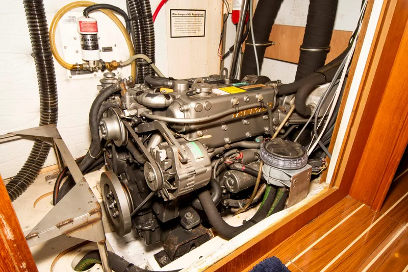 Slide: The Image of Engine compartment of a 2005 Hunter 45 CC sailboat, showcasing detailed mechanical components. - 42