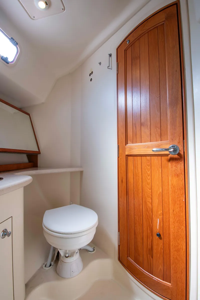 Slide: The Image of 2005 Hunter 45 CC yacht bathroom with wooden door and compact toilet. - 43
