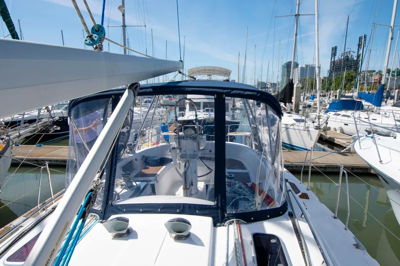 Slide: The Image of Sailboat Hunter 45 CC 2005 docked in marina, surrounded by other boats under clear blue sky. - 9