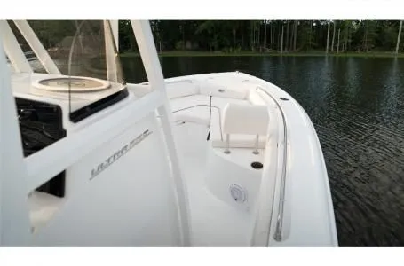 Slide: The Image of 2021 Sea Hunt Ultra 229 boat on a calm lake. - 18