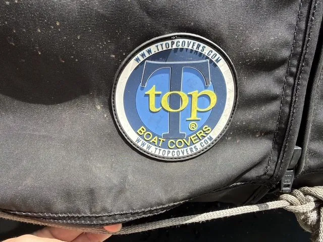 Slide: The Image of Top Boat Covers logo on Sea Hunt Ultra 229 boat, 2021. - 28