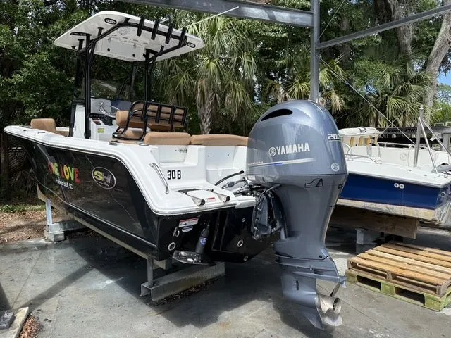 Slide: The Image of 2021 Sea Hunt Ultra 229 boat with Yamaha engine outdoors. - 37
