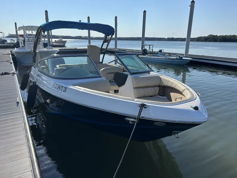 The Image of 2019 Regal 210 OBX boat docked on a sunny day. - 1
