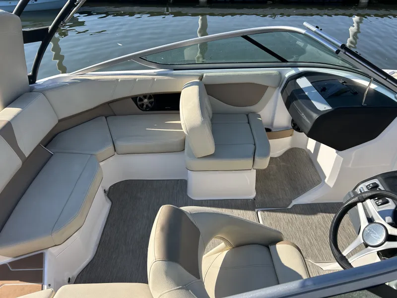 Slide: The Image of Interior of a 2019 Regal 210 OBX boat with beige seating. - 4