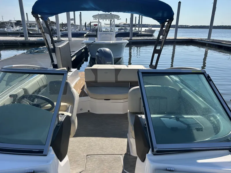 Slide: The Image of Interior view of a 2019 Regal 210 OBX boat at the dock. - 6