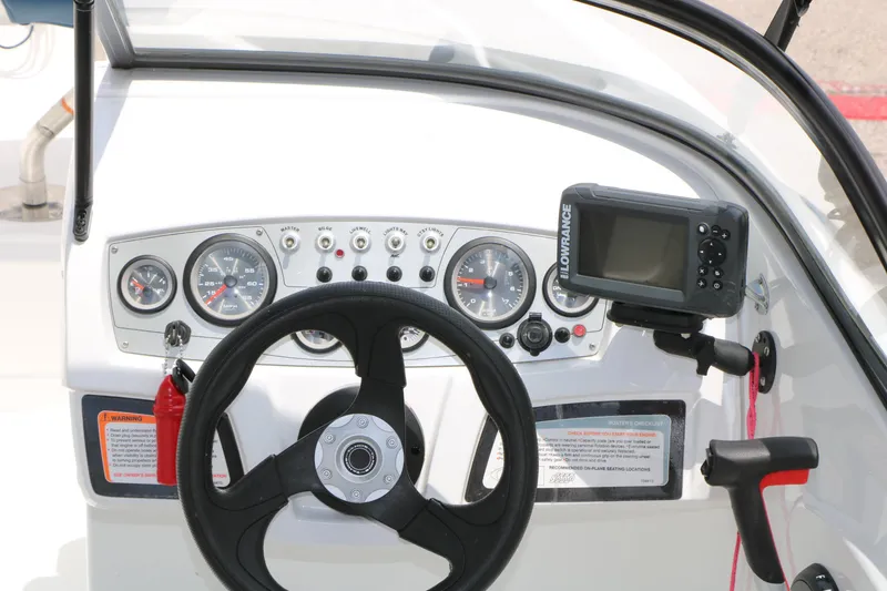 Slide: The Image of Dashboard of a 2018 Tahoe 450 TF boat with steering wheel and navigation system. - 19