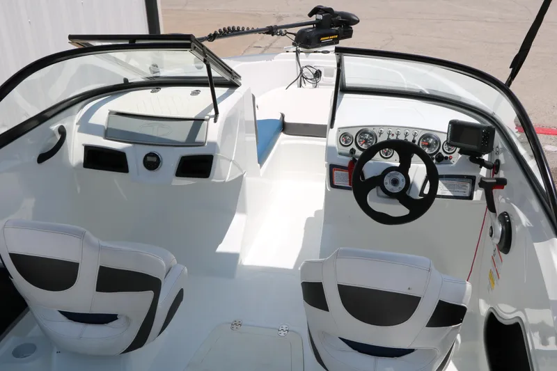 Slide: The Image of Interior of a 2018 Tahoe 450 TF boat with steering wheel and dashboard controls. - 27