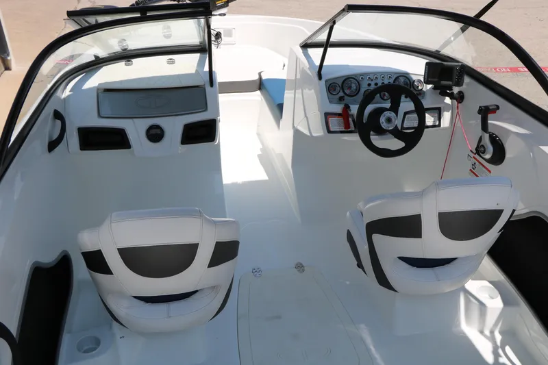 Slide: The Image of Interior of a 2018 Tahoe 450 TF boat, featuring dual seats and a modern dashboard. - 28