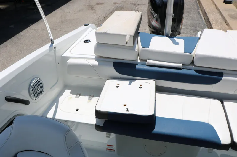 Slide: The Image of 2018 Tahoe 450 TF boat interior with cushioned seating and storage compartments. - 32
