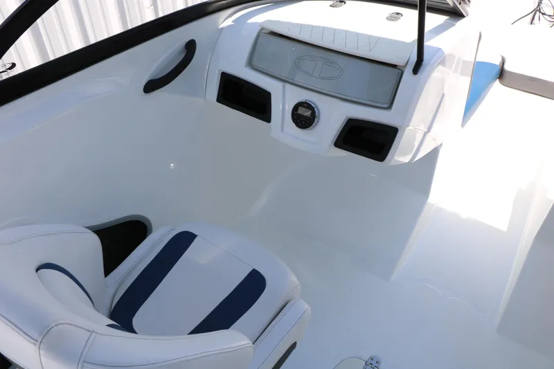 Slide: The Image of Interior of a 2018 Tahoe 450 TF boat, featuring a sleek white and blue design. - 35