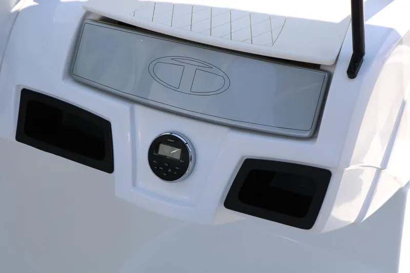 Slide: The Image of 2018 Tahoe 450 TF boat dashboard with control panel and logo. - 36