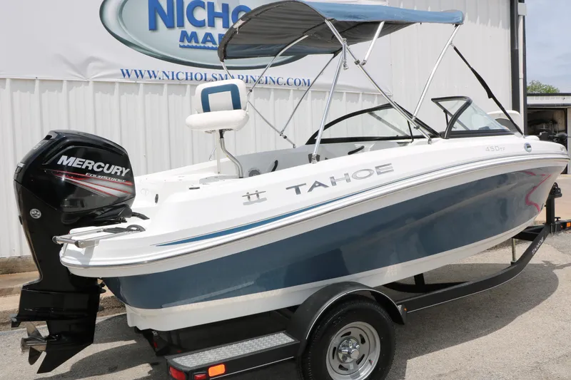 Slide: The Image of 2018 Tahoe 450 TF boat with Mercury engine on trailer, parked outside dealership. - 4