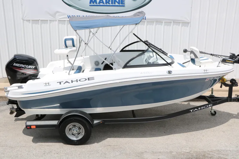 Slide: The Image of 2018 Tahoe 450 TF boat with Mercury engine on trailer, parked outdoors. - 6