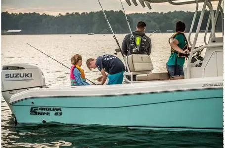 Slide: The Image of Family fishing on Carolina Skiff 23 Ultra Elite boat, 2023 model. - 5