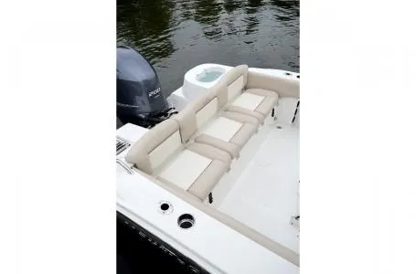 Slide: The Image of 2019 NauticStar 2302 Legacy boat with beige seating area. - 16