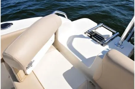 Slide: The Image of NauticStar 2302 Legacy 2019 boat with beige seating and water in the background. - 25