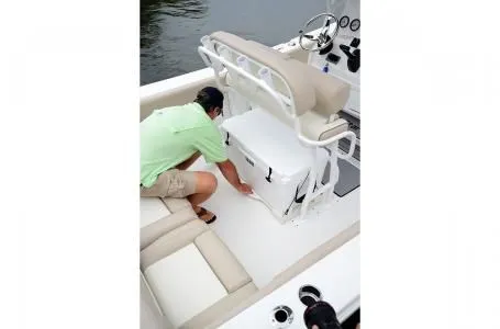 Slide: The Image of Man on 2019 NauticStar 2302 Legacy boat accessing storage. - 3