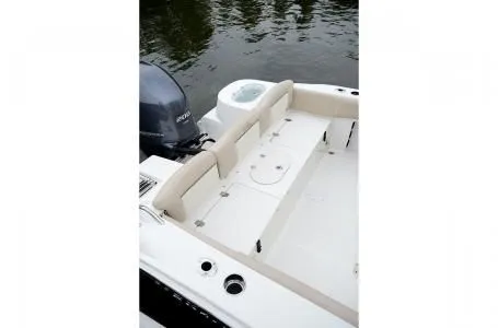Slide: The Image of 2019 NauticStar 2302 Legacy boat with seating area by the water. - 34