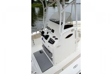 Slide: The Image of 2019 NauticStar 2302 Legacy boat console by the water. - 7